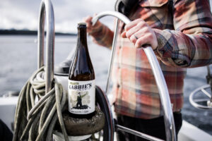 man navigating boat while drinking gabbies cider